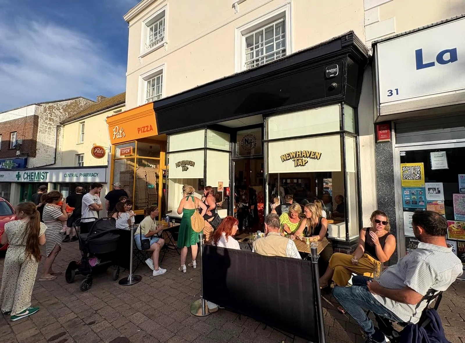 Customers enjoying the High Street atmosphere outside Newhaven Tap